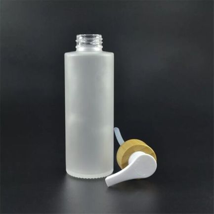1 empty frosted glass bottle of 100 ml with bamboo pump